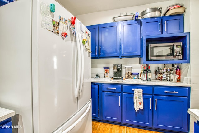 4327 Oxford Ave, El Paso, TX 79903 - indoor bar with freestanding refrigerator, stainless steel microwave, and light wood finished floors