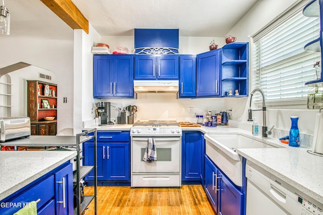 4327 Oxford Ave, El Paso, TX 79903 - kitchen with white appliances, under cabinet range hood, light wood-style flooring, and blue cabinets