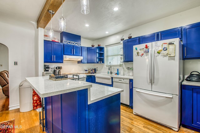 4327 Oxford Ave, El Paso, TX 79903 - kitchen with white appliances, blue cabinetry, under cabinet range hood, a kitchen bar, and light stone countertops