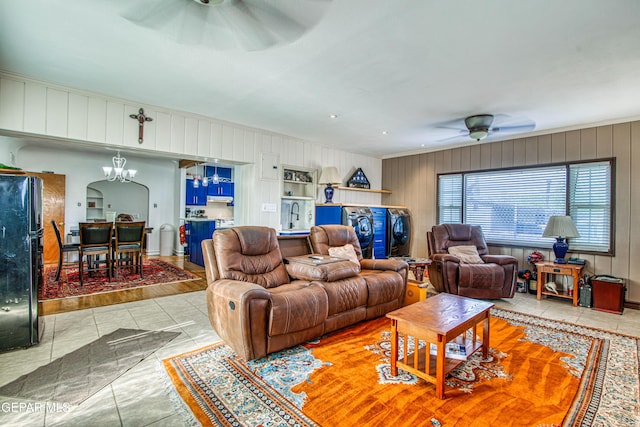 4327 Oxford Ave, El Paso, TX 79903 - living room featuring ceiling fan, tile patterned floors, ornamental molding, wooden walls, and arched walkways