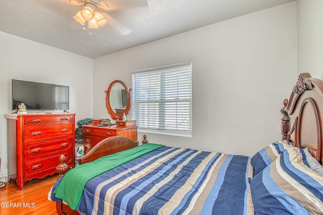 4327 Oxford Ave, El Paso, TX 79903 - bedroom with wood finished floors, a ceiling fan, and a textured ceiling