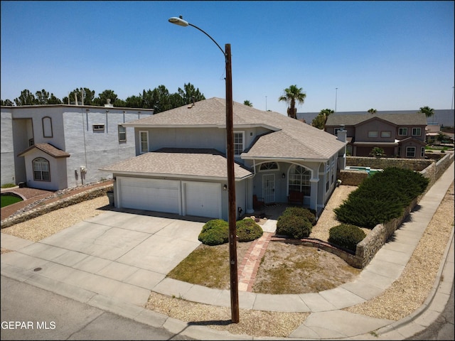 1300 Rosa Guerrero Place, El Paso, TX 79936 - view of front of home with driveway, roof with shingles, an attached garage, and a porch