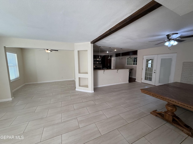 8429 Lasso Cir, El Paso, TX 79907 - unfurnished living room featuring ceiling fan, french doors, a textured ceiling, and light tile patterned flooring