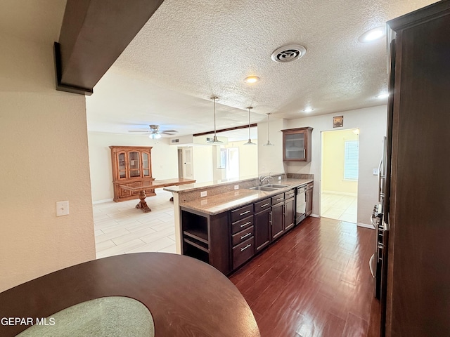 8429 Lasso Cir, El Paso, TX 79907 - kitchen with a peninsula, glass insert cabinets, hanging light fixtures, a textured ceiling, and ceiling fan