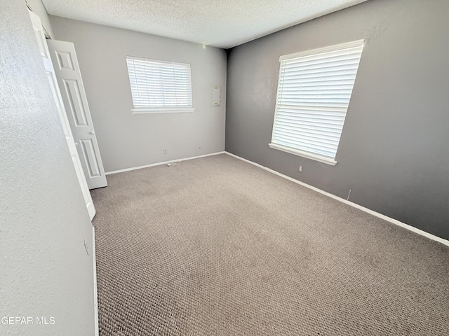 8429 Lasso Cir, El Paso, TX 79907 - carpeted empty room featuring a textured ceiling and baseboards