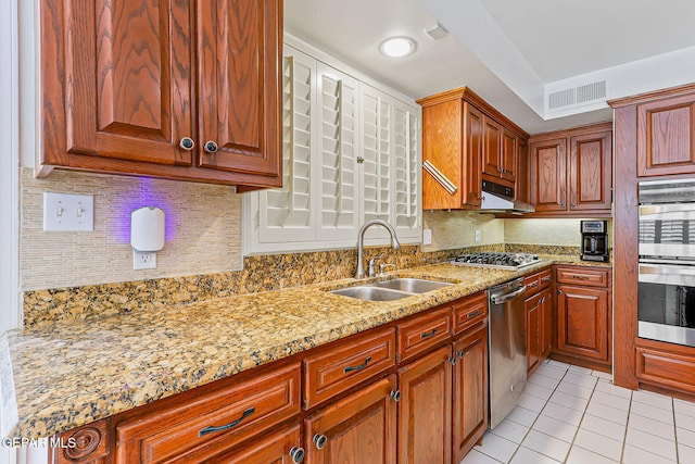 745 Rinconada Ln, El Paso, TX 79932 - kitchen with appliances with stainless steel finishes, light tile patterned flooring, light stone countertops, tasteful backsplash, and range hood