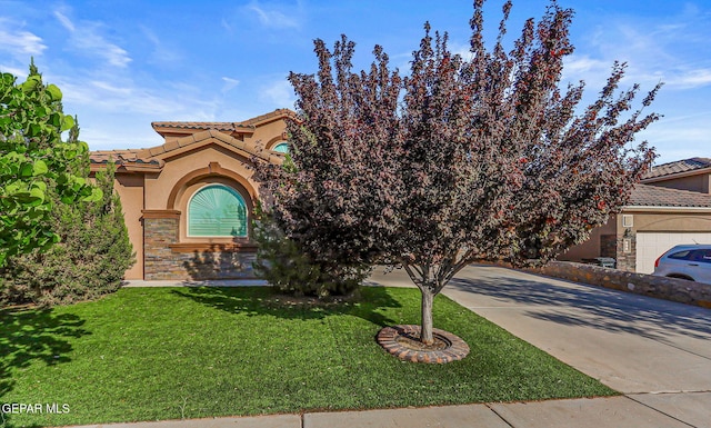448 White Cloud Rd, El Paso, TX 79928 - view of front of property featuring stucco siding, stone siding, a tiled roof, a front yard, and driveway