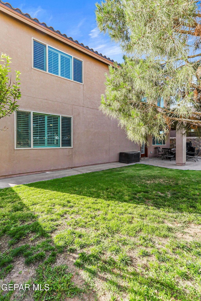 448 White Cloud Rd, El Paso, TX 79928 - rear view of property featuring a lawn, a patio area, and stucco siding