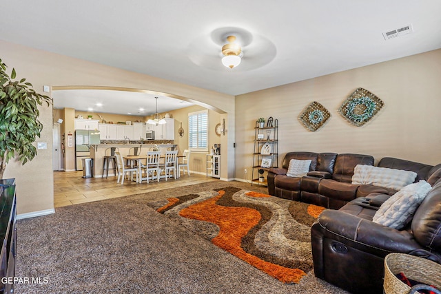 448 White Cloud Rd, El Paso, TX 79928 - living room with arched walkways, ceiling fan, light tile patterned floors, and a chandelier