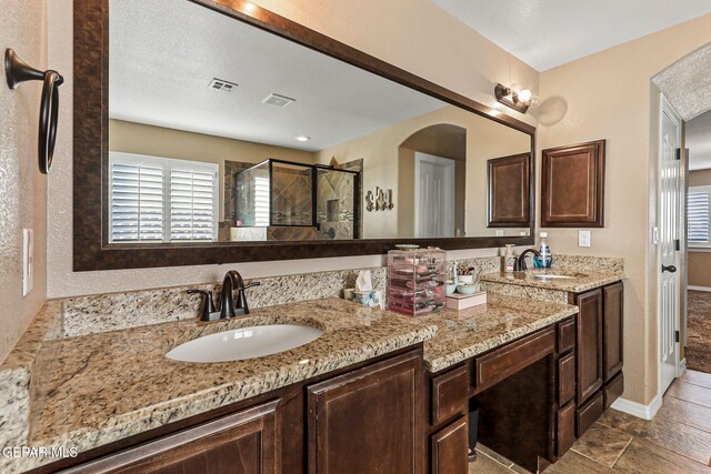 448 White Cloud Rd, El Paso, TX 79928 - full bath with double vanity, healthy amount of natural light, a shower stall, and tile patterned floors