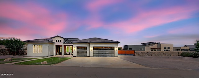 6328 Camino Nogal Dr, El Paso, TX 79932 - view of front of house with an attached garage, concrete driveway, and stucco siding