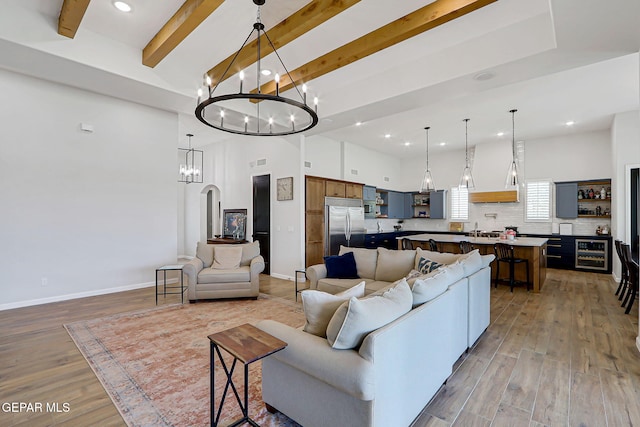 6328 Camino Nogal Dr, El Paso, TX 79932 - living room with a chandelier, beverage cooler, light wood finished floors, recessed lighting, and beamed ceiling