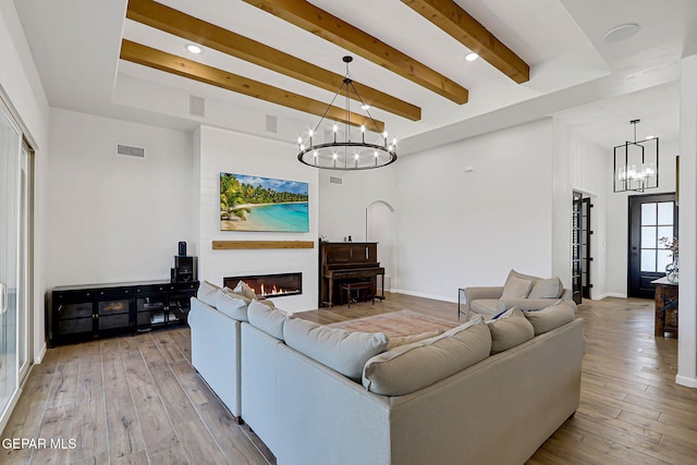 6328 Camino Nogal Dr, El Paso, TX 79932 - living area with a chandelier, a glass covered fireplace, beamed ceiling, wood-type flooring, and recessed lighting
