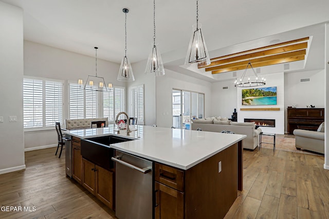6328 Camino Nogal Dr, El Paso, TX 79932 - kitchen with a chandelier, dishwasher, light wood finished floors, light countertops, and pendant lighting