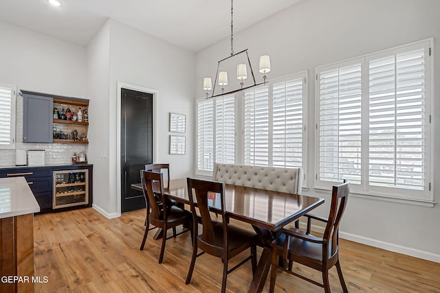6328 Camino Nogal Dr, El Paso, TX 79932 - dining area featuring wine cooler, a bar, and light wood-style floors