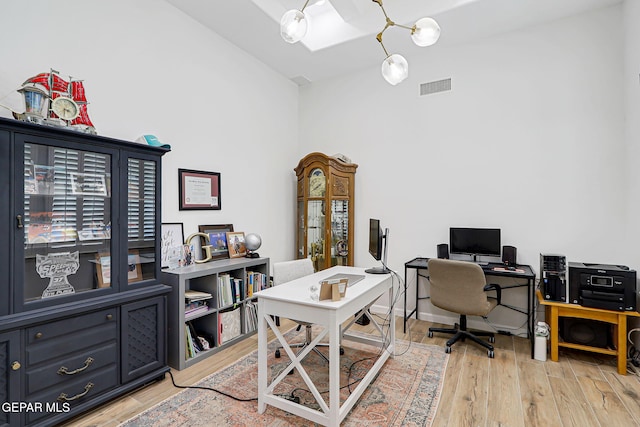 6328 Camino Nogal Dr, El Paso, TX 79932 - office with light wood-style flooring, high vaulted ceiling, and a chandelier