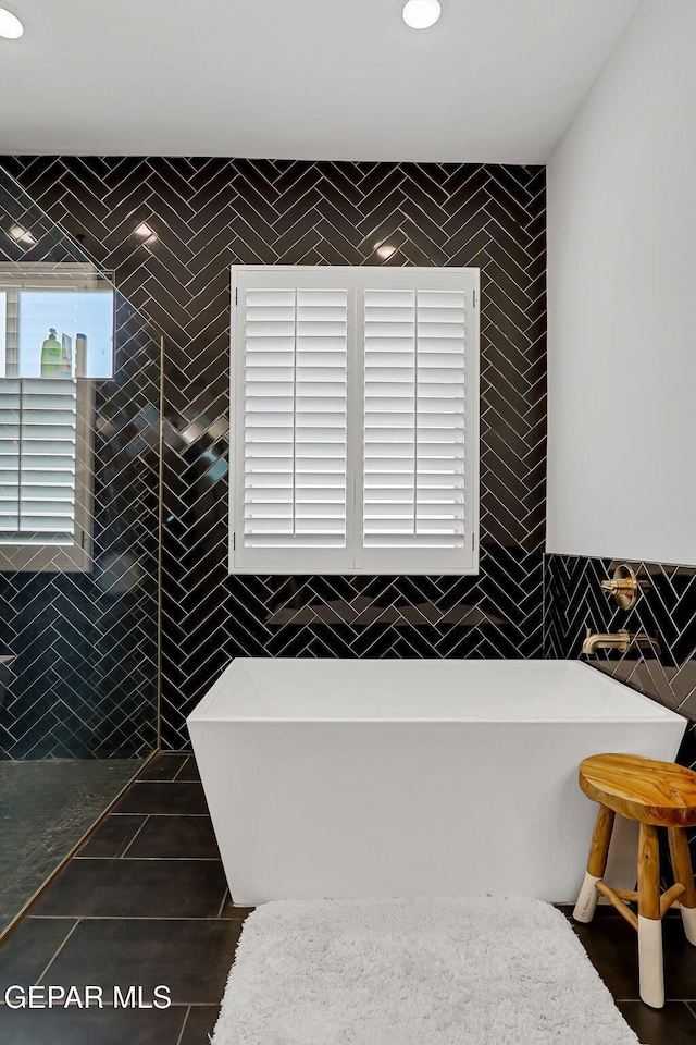 6328 Camino Nogal Dr, El Paso, TX 79932 - full bathroom with tile walls, a freestanding tub, and tile patterned flooring