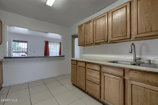 301 Cooley Ave, El Paso, TX 79907 - kitchen with light tile patterned floors and light countertops