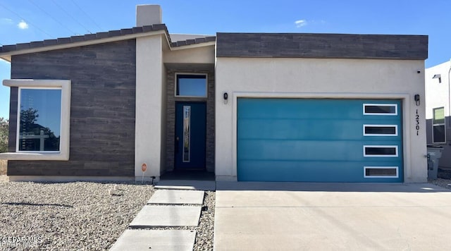 12301 Desert Pine Ave, El Paso, TX 79938 - contemporary house featuring concrete driveway, an attached garage, and stucco siding