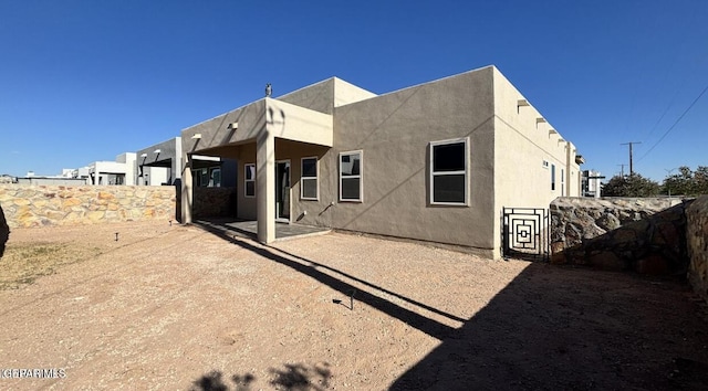 12301 Desert Pine Ave, El Paso, TX 79938 - rear view of house with stucco siding and a patio