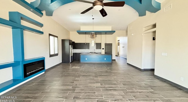 12301 Desert Pine Ave, El Paso, TX 79938 - kitchen featuring ceiling fan, open floor plan, dark wood-type flooring, freestanding refrigerator, and an island with sink