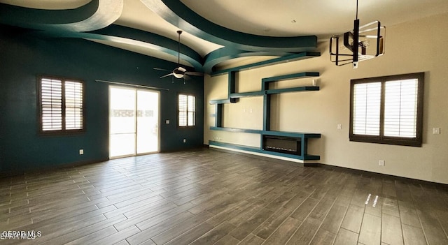 12301 Desert Pine Ave, El Paso, TX 79938 - unfurnished living room featuring ceiling fan, wood finished floors, plenty of natural light, a fireplace, and beamed ceiling