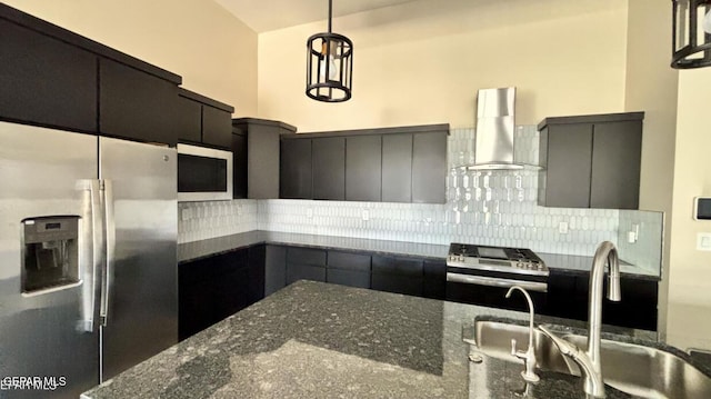 12301 Desert Pine Ave, El Paso, TX 79938 - kitchen with stainless steel appliances, wall chimney exhaust hood, decorative backsplash, hanging light fixtures, and dark stone countertops