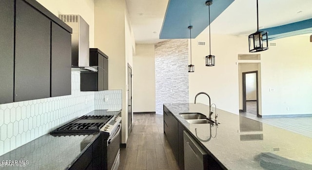 12301 Desert Pine Ave, El Paso, TX 79938 - kitchen featuring appliances with stainless steel finishes, dark wood-style flooring, wall chimney range hood, tasteful backsplash, and pendant lighting
