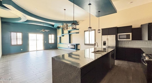 12301 Desert Pine Ave, El Paso, TX 79938 - kitchen featuring stainless steel appliances, a ceiling fan, dark cabinets, a center island with sink, and pendant lighting