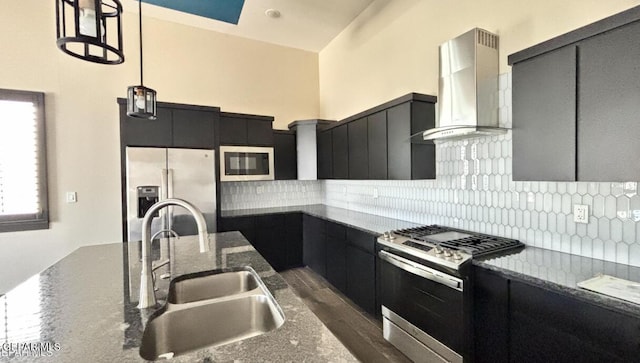 12301 Desert Pine Ave, El Paso, TX 79938 - kitchen featuring stainless steel appliances, wall chimney range hood, dark cabinetry, decorative light fixtures, and backsplash