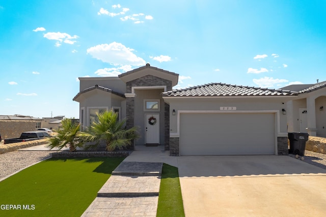 223 Ellesmere Way, El Paso, TX 79928 - view of front facade featuring stone siding, a garage, stucco siding, and concrete driveway