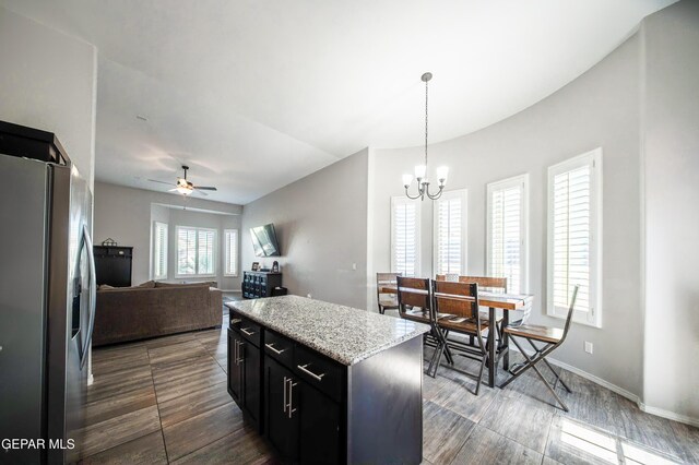 223 Ellesmere Way, El Paso, TX 79928 - kitchen featuring stainless steel fridge, dark cabinets, ceiling fan, a kitchen island, and a chandelier