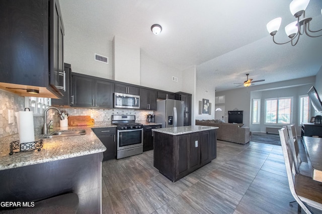 223 Ellesmere Way, El Paso, TX 79928 - kitchen with appliances with stainless steel finishes, a kitchen island, open floor plan, tasteful backsplash, and ceiling fan