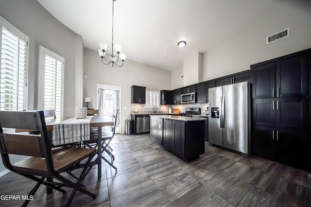 223 Ellesmere Way, El Paso, TX 79928 - kitchen featuring stainless steel appliances, a high ceiling, a chandelier, light countertops, and a kitchen island