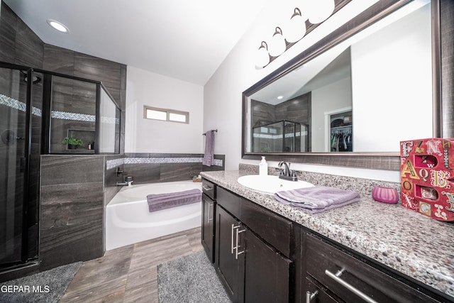223 Ellesmere Way, El Paso, TX 79928 - bathroom featuring a stall shower, vanity, a garden tub, wood finished floors, and a walk in closet