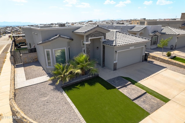 223 Ellesmere Way, El Paso, TX 79928 - view of front of home with stucco siding, a garage, concrete driveway, a tile roof, and a residential view