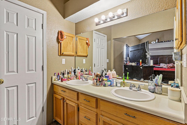 4728 Loma Grande Dr, El Paso, TX 79934 - full bathroom featuring a textured wall and double vanity