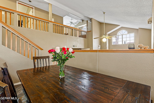 4728 Loma Grande Dr, El Paso, TX 79934 - dining room featuring a ceiling fan, a textured ceiling, a textured wall, wood finished floors, and high vaulted ceiling
