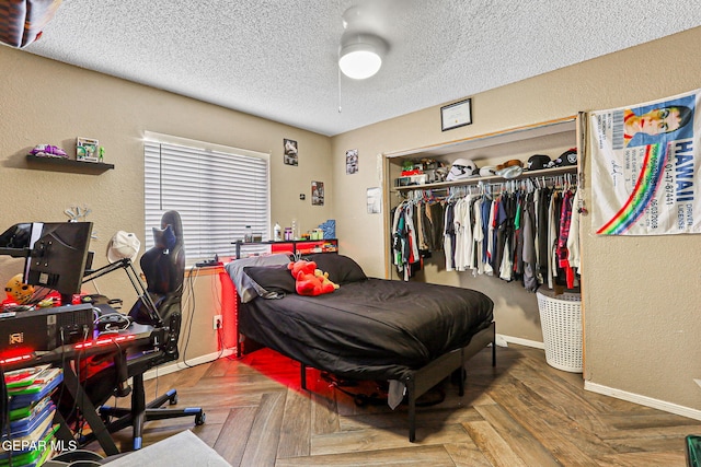 4728 Loma Grande Dr, El Paso, TX 79934 - bedroom featuring a textured ceiling, a closet, a textured wall, and a ceiling fan
