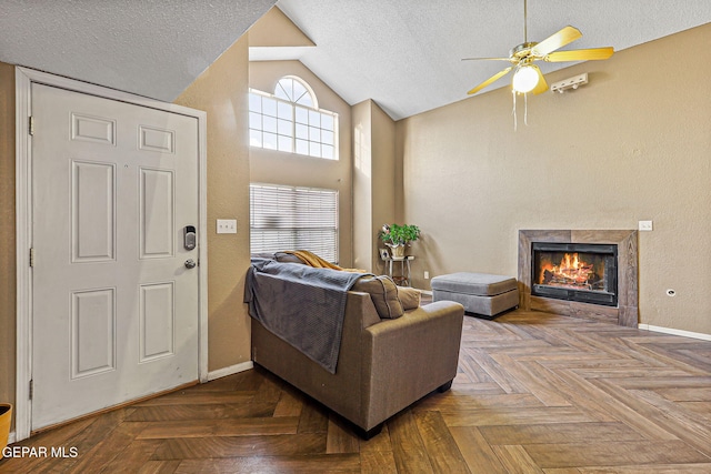 4728 Loma Grande Dr, El Paso, TX 79934 - living area featuring vaulted ceiling, a ceiling fan, a textured ceiling, and a glass covered fireplace