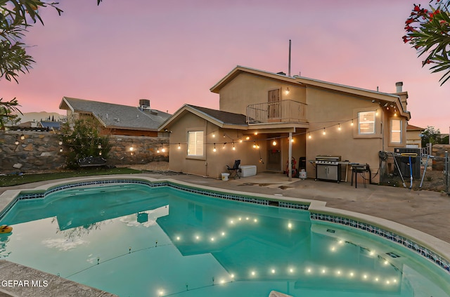 4728 Loma Grande Dr, El Paso, TX 79934 - pool at dusk featuring a patio area, a fenced backyard, and a grill