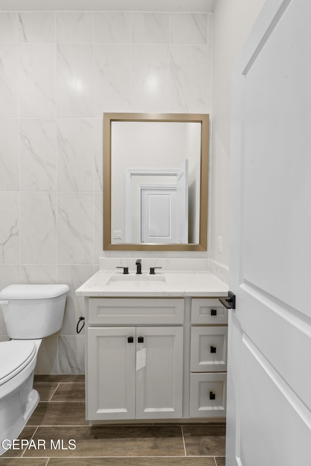 13375 Jeff Winton Dr, El Paso, TX 79928 - bathroom featuring vanity, wood finished floors, and tile walls