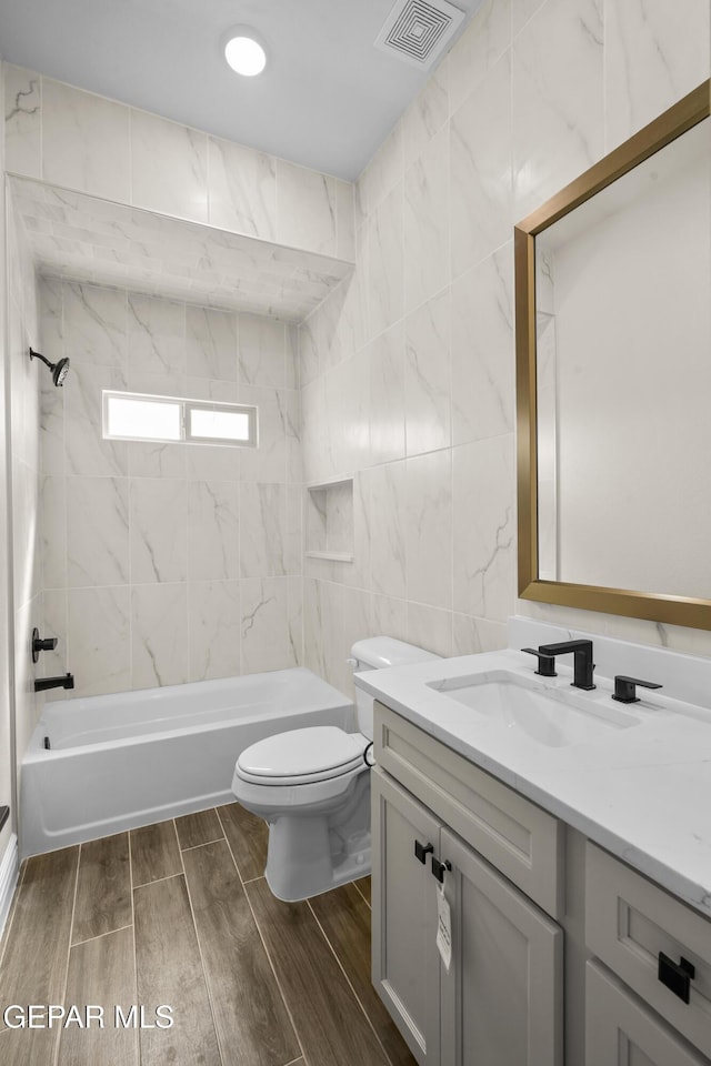 13375 Jeff Winton Dr, El Paso, TX 79928 - full bathroom with vanity, wood finished floors, bathing tub / shower combination, and tile walls