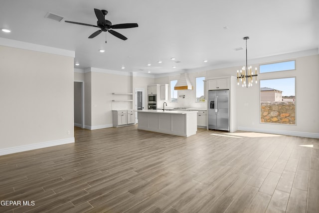 13375 Jeff Winton Dr, El Paso, TX 79928 - unfurnished living room featuring a chandelier, wood finished floors, a ceiling fan, ornamental molding, and recessed lighting
