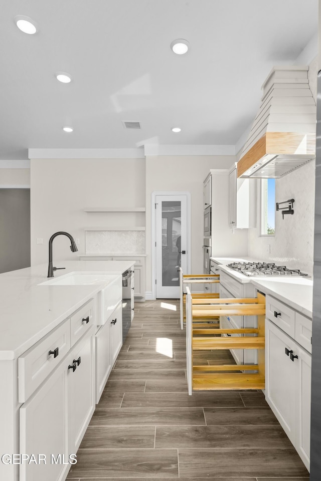 13375 Jeff Winton Dr, El Paso, TX 79928 - kitchen featuring ornamental molding, appliances with stainless steel finishes, white cabinetry, light countertops, and recessed lighting