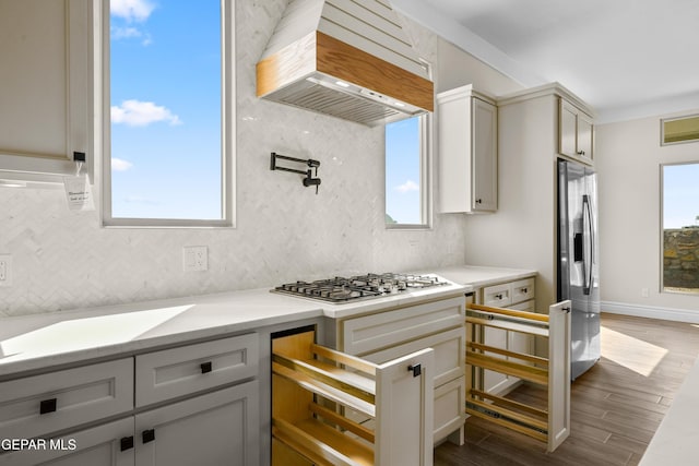 13375 Jeff Winton Dr, El Paso, TX 79928 - kitchen featuring custom range hood, stainless steel appliances, decorative backsplash, dark wood finished floors, and plenty of natural light