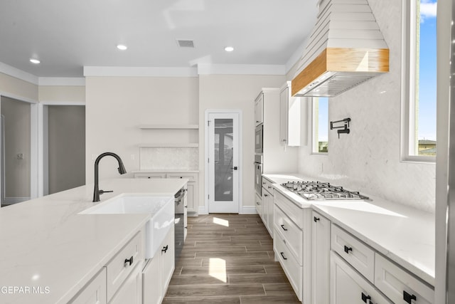 13375 Jeff Winton Dr, El Paso, TX 79928 - kitchen with stainless steel appliances, custom range hood, open shelves, dark wood-style floors, and white cabinets