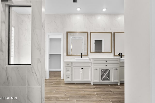 13375 Jeff Winton Dr, El Paso, TX 79928 - full bathroom featuring double vanity and wood tiled floors