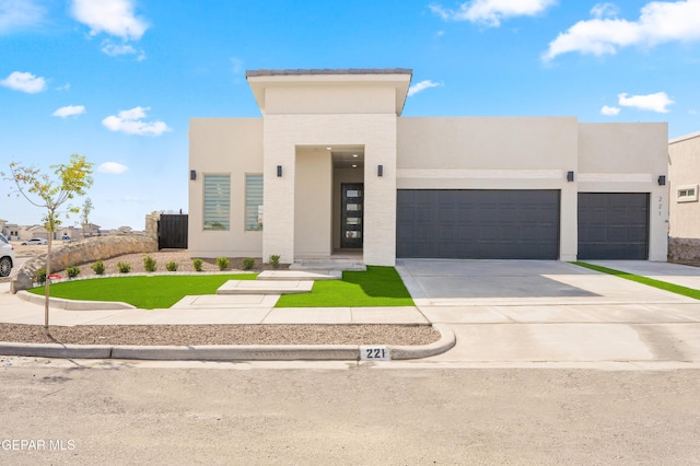 13375 Jeff Winton Dr, El Paso, TX 79928 - contemporary home featuring an attached garage, driveway, stucco siding, and a front lawn