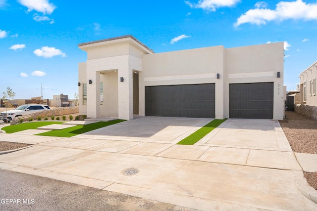 13375 Jeff Winton Dr, El Paso, TX 79928 - modern home featuring an attached garage, driveway, and stucco siding